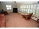Living room with brown leather furniture, carpeting, and large windows at 1879 Lake Emma Rd, Longwood, FL 32750
