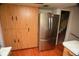 Kitchen boasts stainless steel refrigerator and ample wood cabinetry at 1879 Lake Emma Rd, Longwood, FL 32750