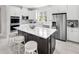 Modern kitchen with white cabinets, stainless steel appliances, and a large island at 2675 Ginseng Ivy St, Apopka, FL 32703