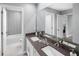 Modern bathroom with double vanity, updated fixtures and patterned tile at 2675 Ginseng Ivy St, Apopka, FL 32703