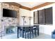 Outdoor lounge with fireplace and bar-height tables at 7049 Oakwood St, Davenport, FL 33837
