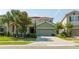 Two-story home with a two-car garage and landscaping at 7049 Oakwood St, Davenport, FL 33837