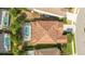 Top-down view of single Gathering home with tile roof and pool at 7049 Oakwood St, Davenport, FL 33837