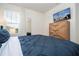 Main bedroom with a king-size bed and a large dresser at 7049 Oakwood St, Davenport, FL 33837