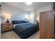 Main bedroom with a king-size bed, nightstands and dresser at 7049 Oakwood St, Davenport, FL 33837