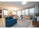 Bright living room with sectional sofa and large windows at 7049 Oakwood St, Davenport, FL 33837