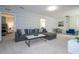 Bright living room featuring a comfortable sectional sofa and geometric wallpaper at 7049 Oakwood St, Davenport, FL 33837
