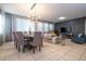Open dining room with a six-person table and modern lighting at 7049 Oakwood St, Davenport, FL 33837