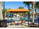 Covered cabana with lounge chairs near the pool at 7049 Oakwood St, Davenport, FL 33837
