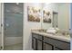 Bathroom boasts a double vanity with granite countertop and a shower/tub combo at 7049 Oakwood St, Davenport, FL 33837