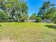 Large grassy backyard with mature trees at 111 10Th St, New Smyrna Beach, FL 32168