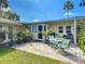 Back patio with seating area and tropical plants at 111 10Th St, New Smyrna Beach, FL 32168
