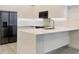 Modern kitchen island with white quartz countertop at 17435 Hidden Forest Dr, Clermont, FL 34714