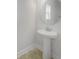 Small bathroom with pedestal sink and round mirror at 3690 Sagefield Dr, St Cloud, FL 34773