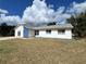 House exterior showcasing a blue and white color scheme and double doors at 7313 Cabor Ct, Orlando, FL 32818