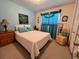 Bright bedroom with a double bed, nightstands, and ample closet space at 7313 Cabor Ct, Orlando, FL 32818