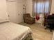 Bedroom with a double bed, recliner, and workspace at 7313 Cabor Ct, Orlando, FL 32818