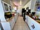 White kitchen with ample cabinetry and appliances at 7313 Cabor Ct, Orlando, FL 32818