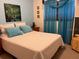 Cozy bedroom with light colored bedding and decor at 7313 Cabor Ct, Orlando, FL 32818