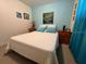 Well-lit bedroom with a queen-size bed and light teal accents at 7313 Cabor Ct, Orlando, FL 32818