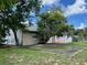 Large backyard with mature trees and a patio at 7313 Cabor Ct, Orlando, FL 32818