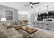 Open living room with beige couch, coffee table, and kitchen views at 4243 Paragraph Dr, Kissimmee, FL 34746
