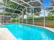 Relaxing screened-in pool with patio furniture at 215 Riggs Cir, Davenport, FL 33897