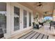 Spacious covered balcony with tiled flooring, comfortable seating, and ceiling fan at 1160 Grand Traverse Pkwy, Reunion, FL 34747