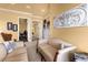 Light and airy sitting area with sofas and access to other rooms at 1160 Grand Traverse Pkwy, Reunion, FL 34747