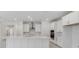 Modern white kitchen with large island and stainless steel appliances at 2985 Water Clover Ct, Apopka, FL 32712