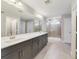 Bathroom with gray double vanity, quartz countertop and a walk-in shower at 2993 Water Clover Ct, Apopka, FL 32712