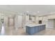 Modern kitchen with a large island and white cabinets at 2993 Water Clover Ct, Apopka, FL 32712