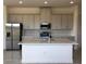 Modern kitchen with island, stainless steel appliances, and white cabinets at 2323 Datura Loop, St Cloud, FL 34772