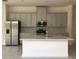 Modern kitchen with an island, stainless steel appliances and light gray cabinets at 2331 Datura Loop, St Cloud, FL 34772
