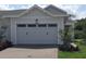Two-car garage with a brick paved driveway at 2333 Datura Loop, St Cloud, FL 34772