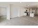 Open concept living room and kitchen area with grey carpeting at 1357 Current Pl, Haines City, FL 33844