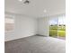 Light and airy bedroom with grey carpet and backyard view at 1357 Current Pl, Haines City, FL 33844