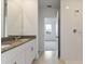 Modern bathroom with double vanity, shower, and view into bedroom at 1357 Current Pl, Haines City, FL 33844