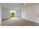 Spacious bedroom featuring grey carpet and access to the backyard at 1357 Current Pl, Haines City, FL 33844