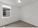 Bright bedroom with neutral walls and carpet, featuring a large window and closet at 1357 Current Pl, Haines City, FL 33844