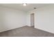 Simple bedroom with grey carpet, door to bathroom, and an open layout at 1357 Current Pl, Haines City, FL 33844