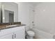 Clean bathroom with granite vanity and a bathtub at 1357 Current Pl, Haines City, FL 33844