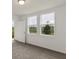 Bright bedroom with two large windows and door to outside at 1357 Current Pl, Haines City, FL 33844