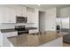 Modern kitchen with stainless steel appliances and granite countertops at 1357 Current Pl, Haines City, FL 33844