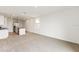 Open living room with kitchen access and neutral carpeting at 1357 Current Pl, Haines City, FL 33844