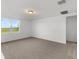 Spacious bedroom with neutral carpeting and window view at 2470 Leeds St, Haines City, FL 33844