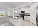 Open concept kitchen with island, granite countertops, and stainless steel appliances at 2466 Leeds St, Haines City, FL 33844