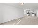 Open living room with kitchen views and neutral carpeting at 2466 Leeds St, Haines City, FL 33844
