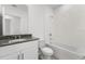 Clean bathroom with a tub, toilet and granite countertop at 2466 Leeds St, Haines City, FL 33844