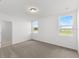 Bright bedroom with two windows and carpet flooring at 2466 Leeds St, Haines City, FL 33844
